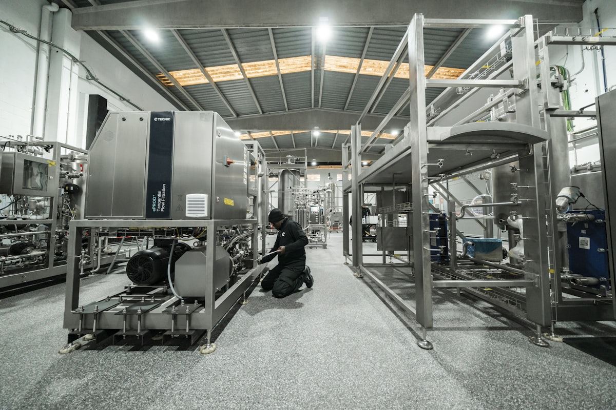 A technician servicing industrial equipment in a factory